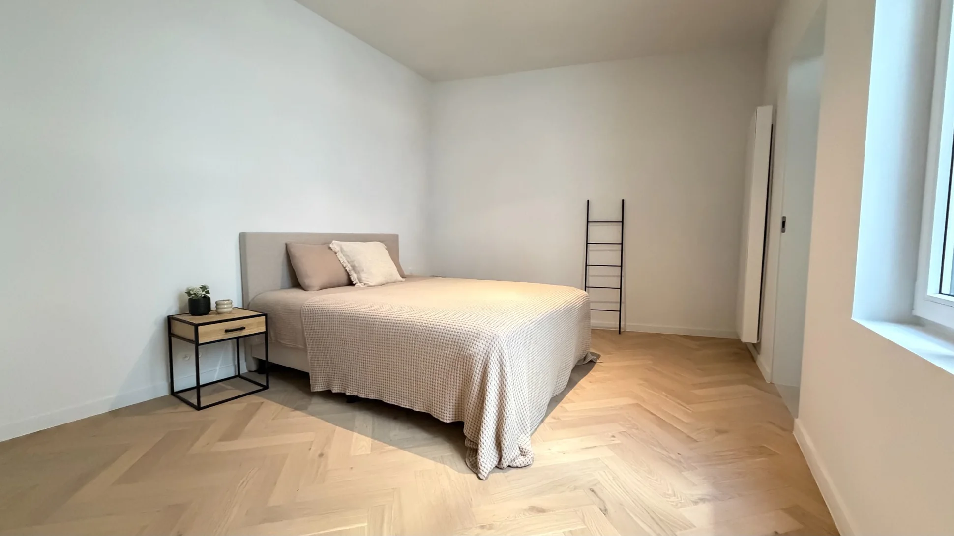 Soft, neutral bedroom with light timber floor